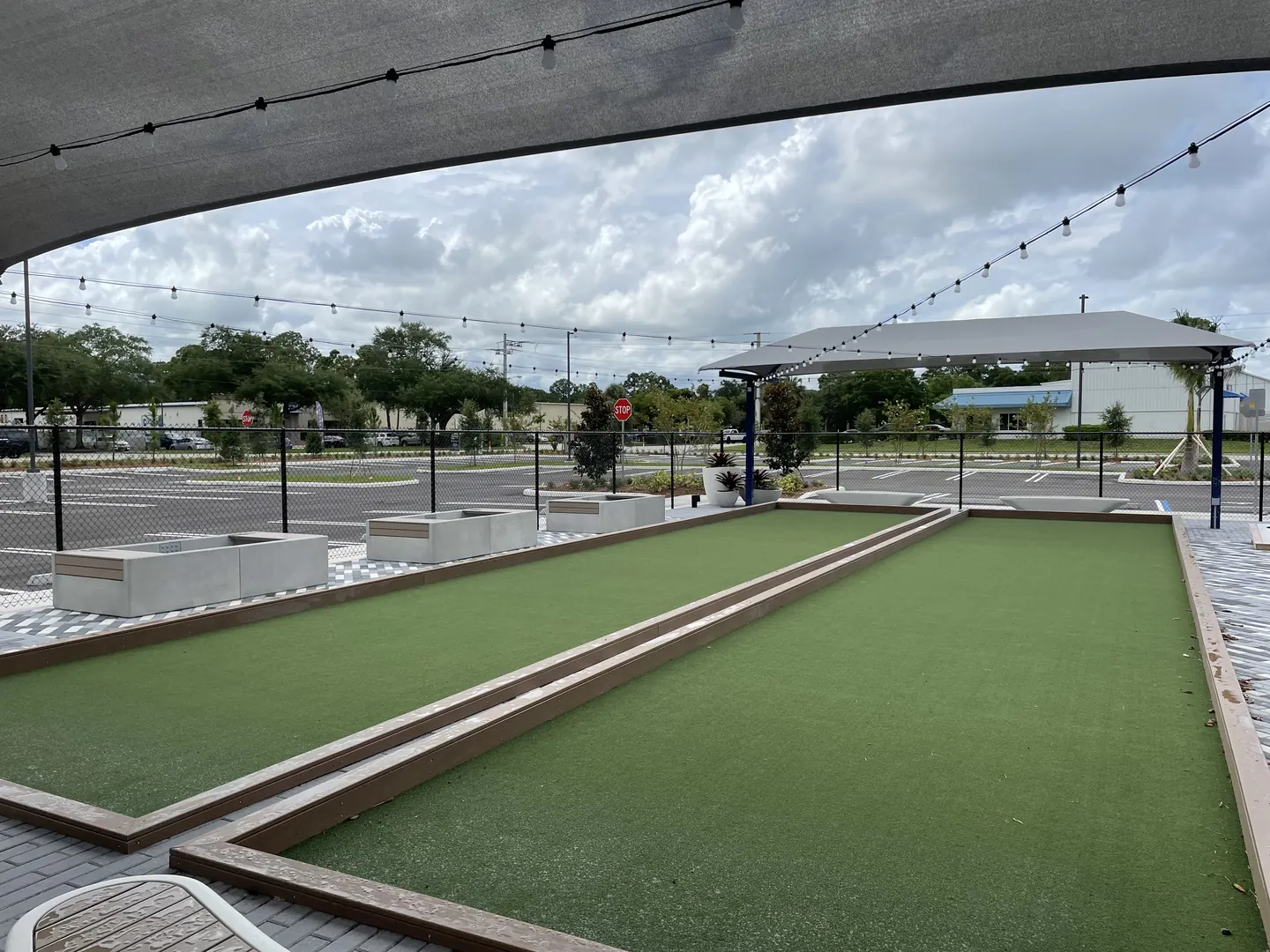 Outdoor bocce courts under a shade canopy