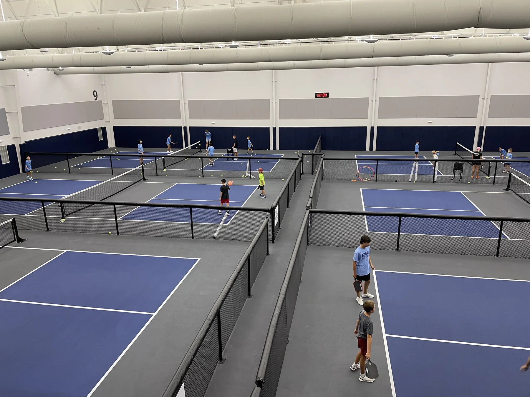 Members playing on the indoor courts at The Pickleball Club