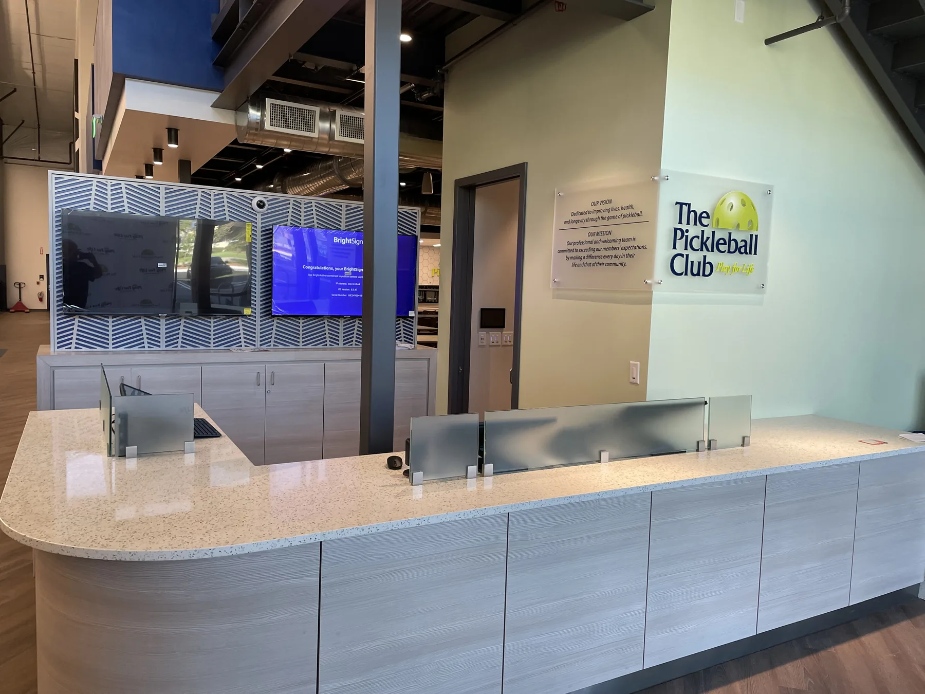 The reception desk and club sign at The Pickleball Club