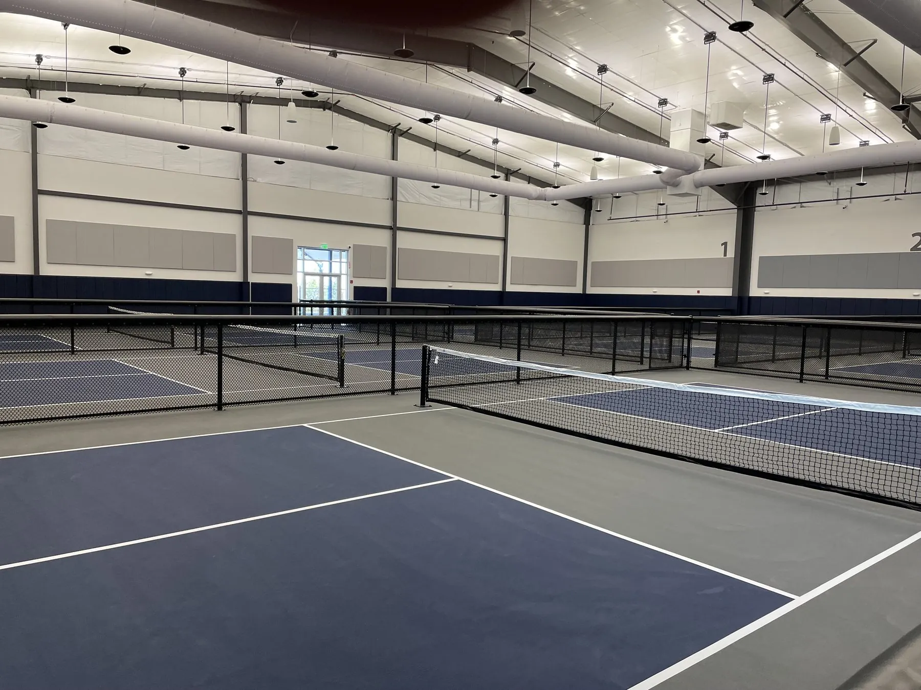 Indoor courts at a Pickleball Club athletic facility