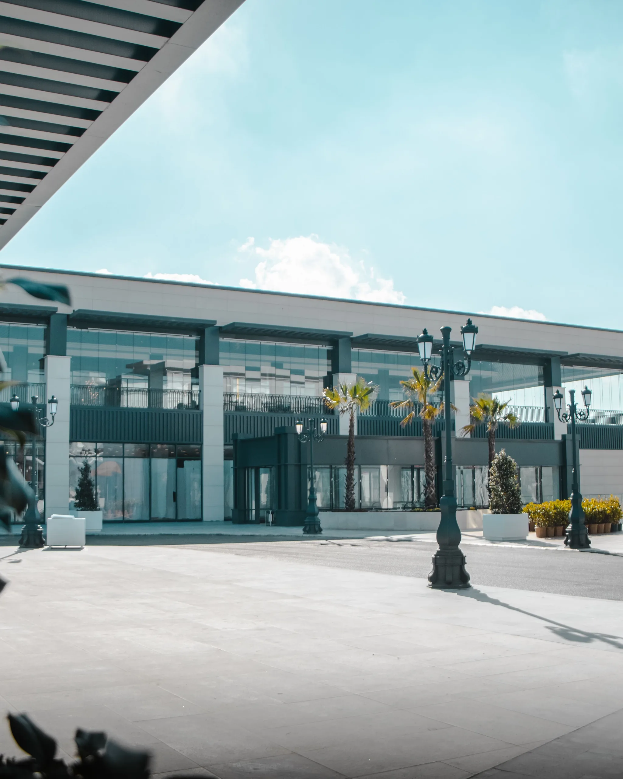 A modern open-air retail plaza on a bright day